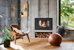 Interiør og living fotografi. Lækker stue med tændt brændeovn fotograferet til livsstil magasin.